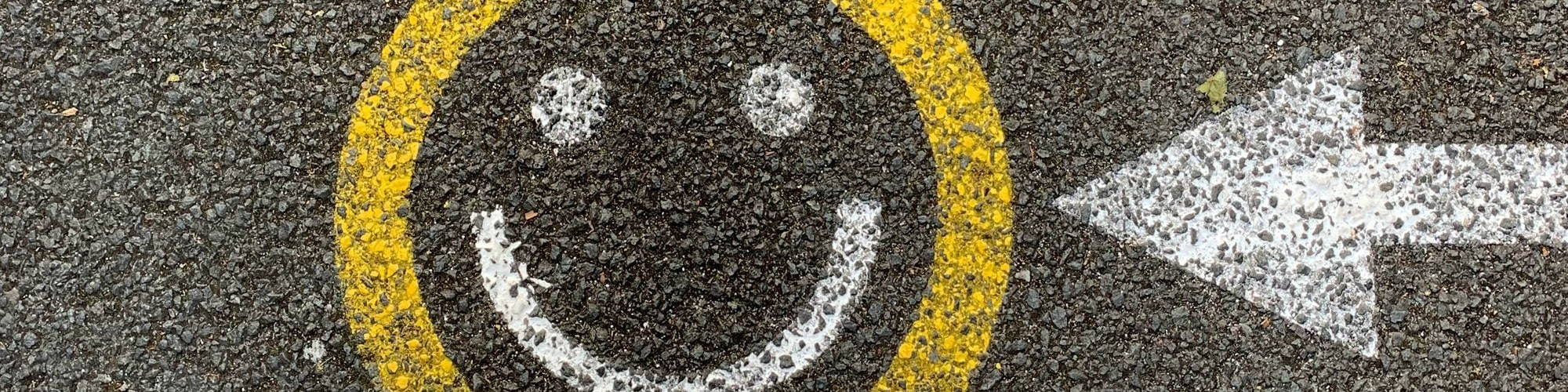 A yellow smiley face drawing on the road